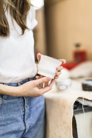girl potter in a workshop works behind a potter's wheel