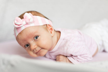 newborn baby lying on tummy