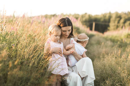 happy family, mother with two children, daughtersの写真素材