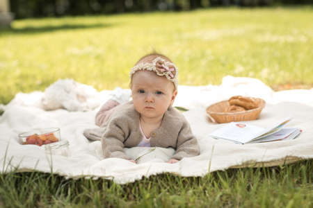 child lies on a blanket at a summer picnicの写真素材