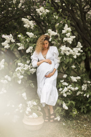 pregnant girl in the lilac gardenの写真素材