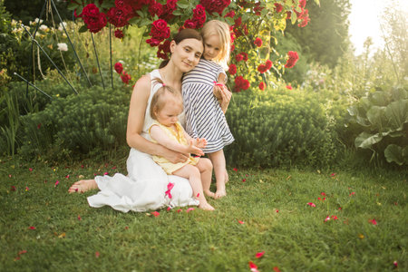 mother hugs her daughter, relax, collect a bouquet of roses