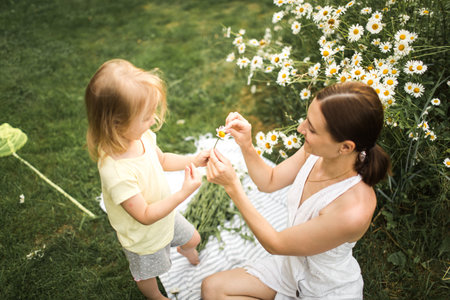 mother and daughter play chamomile, loves not loves, guessの写真素材