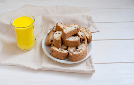 yellow bright drink with cookies on a plate