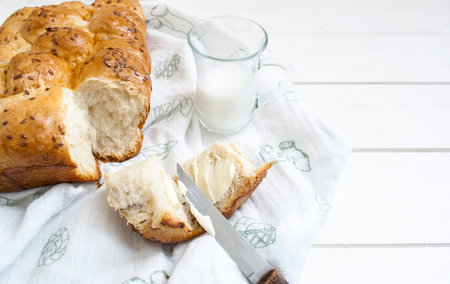 fresh wheat buns with sesame seeds for breakfast with buttered butter