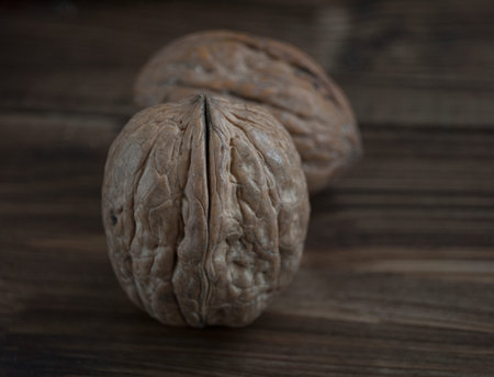 walnut whole macro on a wooden table in low key