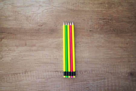 Colored pencils with eraser on wooden backgroundの写真素材