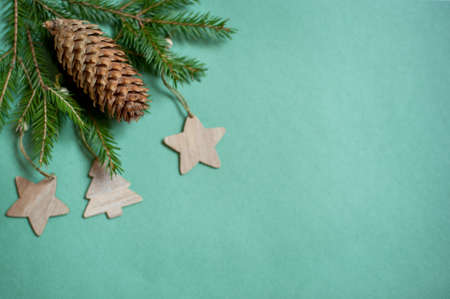 branches of a Christmas tree and fir cone and decoration on a Christmas tree green background.の写真素材
