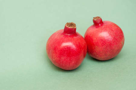 red pomegranate on a green backgroundの写真素材