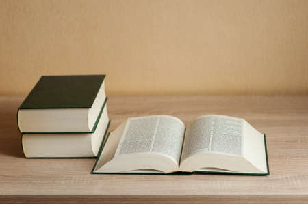 books in a pile on the table. neutral backgroundの写真素材