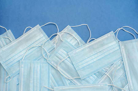 Medical masks on a blue background. Many masks. Background from masksの写真素材