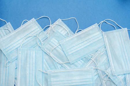 Medical masks on a blue background. Many masks. Background from masksの写真素材