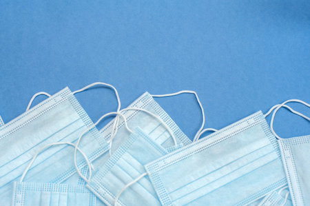 Medical masks on a blue background. Many masks. Background from masks