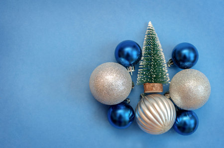 Silver and blue Christmas balls on a blue background
