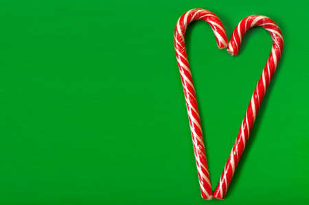 Heart, caramel sticks on a green backgroundの写真素材