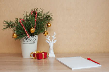 Christmas decor on the table, Christmas tree, small red box, white deerの写真素材