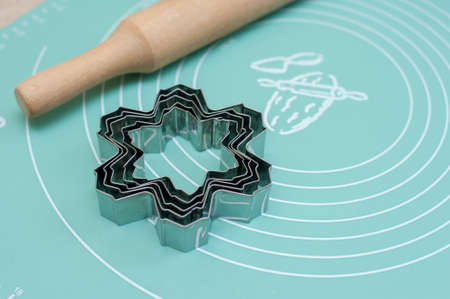 Cookie cutters and rolling pin on a silicone matの写真素材