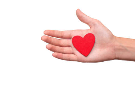 Small red heart is held by a hand on a white backgroundの写真素材