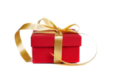 Red gift box with gold ribbon and bow on white backgroundの写真素材