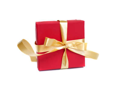 Red gift box with gold ribbon and bow on white backgroundの写真素材