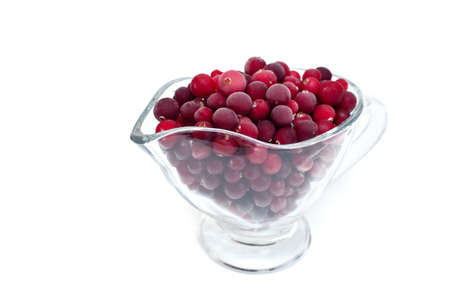 frozen cranberries in a cup on a white backgroundの写真素材