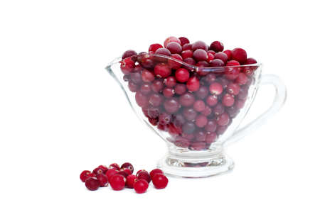 frozen cranberries in a cup on a white backgroundの写真素材