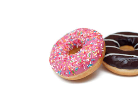 Sweet pink and chocolate donuts on white backgroundの写真素材