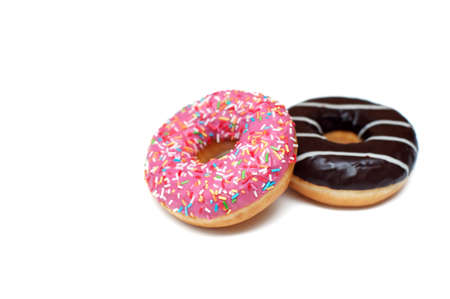 Sweet pink and chocolate donuts on white backgroundの写真素材