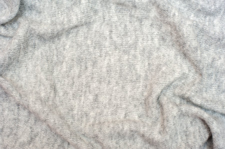 Knitted gray background. Textures for wallpapers and backgrounds.