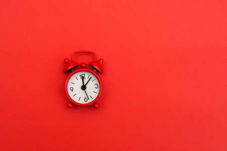 Red alarm clock on red backgroundの写真素材