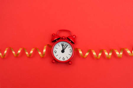 Red alarm clock on red backgroundの写真素材