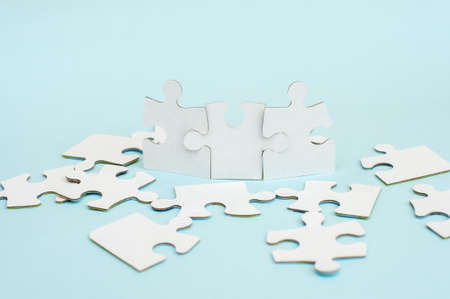 White puzzle on a blue background. Business conceptの写真素材