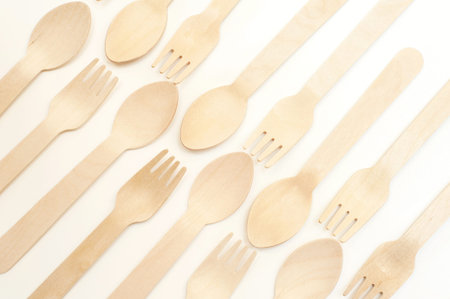 Wooden spoons and forks on a white background. Ecology concept