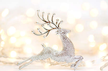 Christmas, winter, new year concept. Deer, Christmas tree and lights in the background. Vetrikalny photoの写真素材