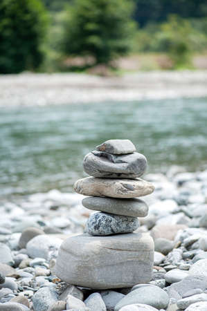Stone tower on the beach and blur background, vertical photoの写真素材