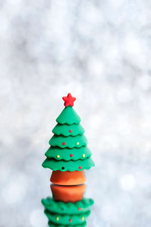 Small toy Christmas tree on an abstract background. Vertical photoの写真素材