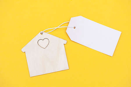 Eco friendly house with blank sign on yellow backgroundの写真素材
