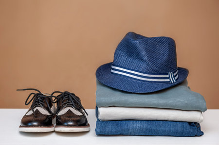 Clothing concept. Stack of clothes and shoes blue navy tone