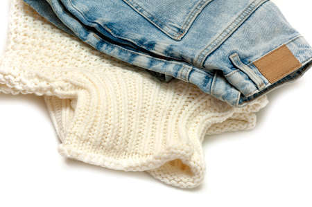 Sweater and jeans close-up on a white background. Circular fashion,swap clothes idea,rentの写真素材