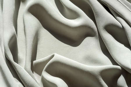 Gray cotton texture. Clothing cotton background whit foldsの写真素材