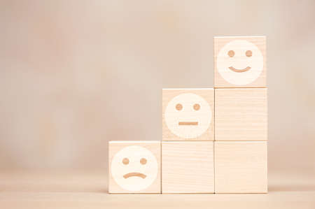 Wooden cubes with emotions. customer satisfaction concept.の写真素材