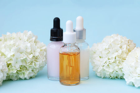 facial concept. Serum different bottles on blue backgroundの写真素材