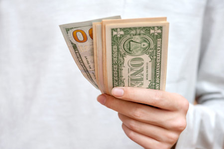 American dollar bills in hands close up.の写真素材