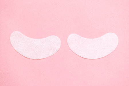 White under eye patches on pink backgroundの写真素材