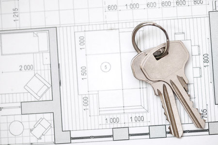 Silver house keys composition with architectural drawingの写真素材