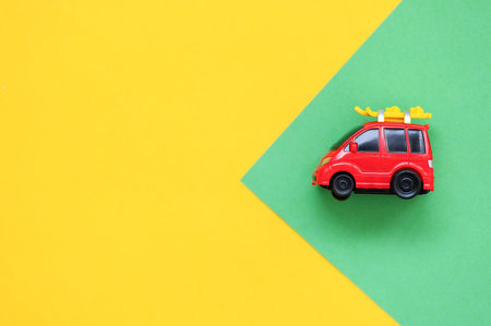 Red car on green and yellow background. Holidays and travel conceptsの写真素材