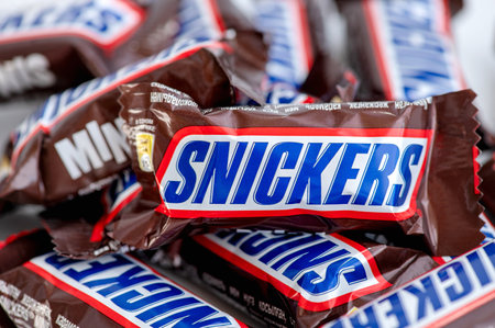 Smolensk, Russian Federation - June 08, 2023. Pile of Snickers mini chocolate bars close-upのeditorial素材