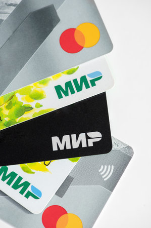 Smolensk, Russia - October 20, 2023: plastic cards on a white background, isolate, financial systems Mir and Master Card. Vertical photoのeditorial素材