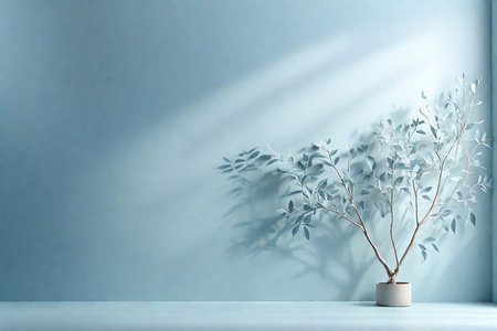 Minimalistic abstract gentle light blue background for product presentation with shadow from tree branches on wall.の素材