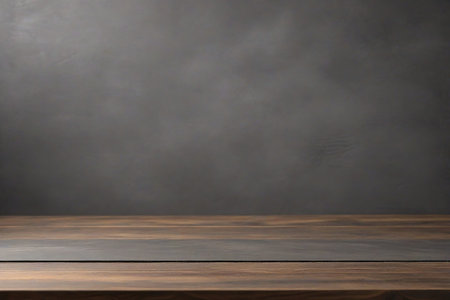 Empty wooden tabletop with defocused dark concrete wall background. Template for product demonstrationの素材